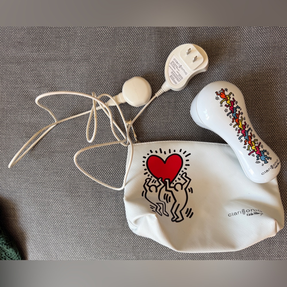 Clarisonic White Skincare Tool with Red and Black Design